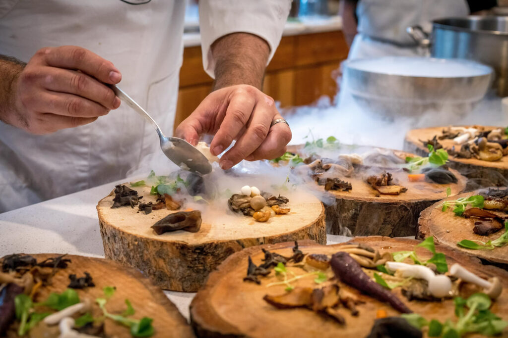 Chef-preparing-vegetable-dish-on-tree-slab